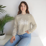 She is STRONG - Unisex Heavy Blend™ Crewneck Sweatshirt - Front White Logo - Plain Back
